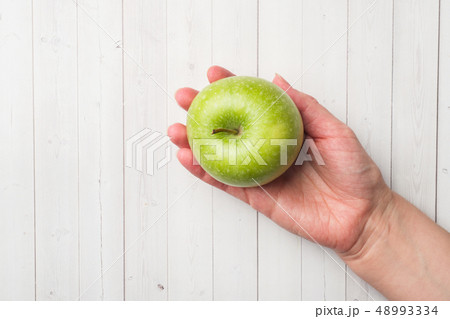 Diet concept. green Apple rests in the palm Diet concept. green Apple rests in the palm 48993334
