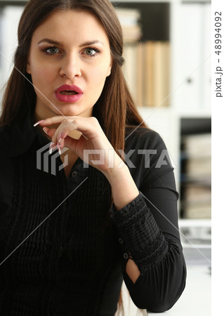 Beautiful smiling clerk girl at workplace talk to visitor Beautiful smiling clerk girl at workplace talk to visitor 48994092