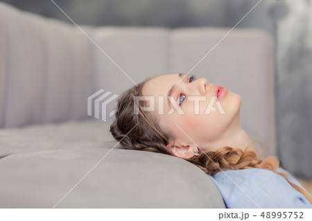 Frustrated blonde teenager being deep in thoughts Frustrated blonde teenager being deep in thoughts 48995752