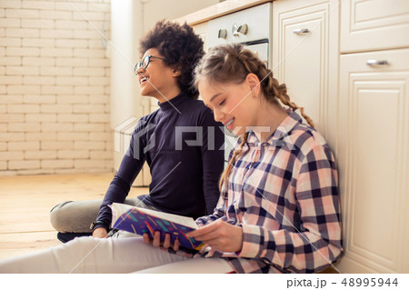 Charming blonde girl keeping smile on her face Charming blonde girl keeping smile on her face 48995944