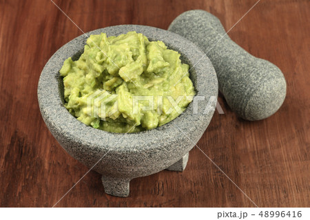 A photo of guacamole sauce in a molcajete, traditional Mexican bowl A photo of guacamole sauce in a molcajete, traditional Mexican bowl 48996416
