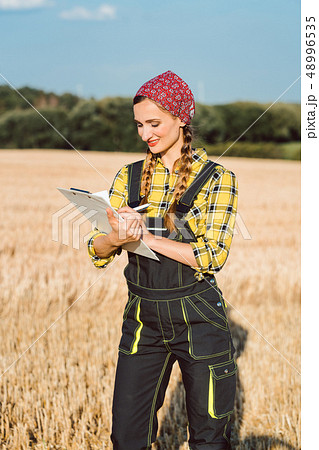 Farmer doing business administration on the field Farmer doing business administration on the field 48996535