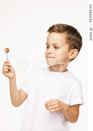 little boy with a lollipop on a white background little boy with a lollipop on a white background 48998639