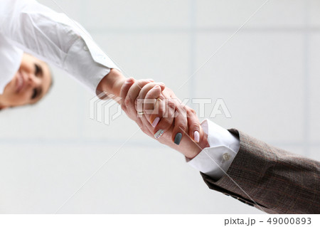 Man in suit and tie give hand as hello in office 49000893
