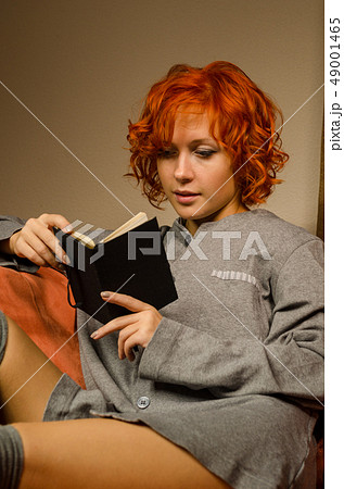 Red woman reading Red woman reading 49001465