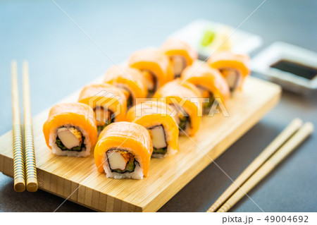Salmon fish meat sushi roll maki on wood plate Salmon fish meat sushi roll maki on wood plate 49004692