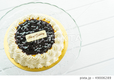Blueberry cheese cake with happy birthday sign on top 49006289