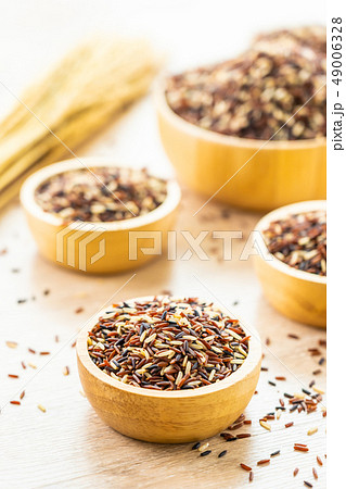 Raw rich brown in wooden bowl Raw rich brown in wooden bowl 49006328