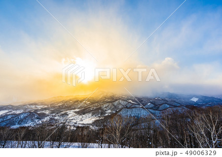 Beautiful landscape with mountain around tree in snow winter season at sunset time Beautiful landscape with mountain around tree in snow winter season at sunset time 49006329