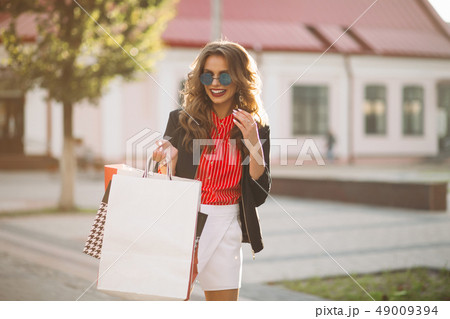 Fashionable brunette girl with colorful paper 49009394