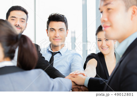 Business people putting their hands together. 49012801