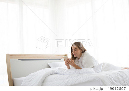 Relaxed caucasian woman using a smartphone 49012807