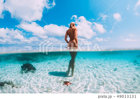 Beautiful woman in tropical ocean, underwater 49013131
