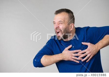 Man having heart pain attack 49015986