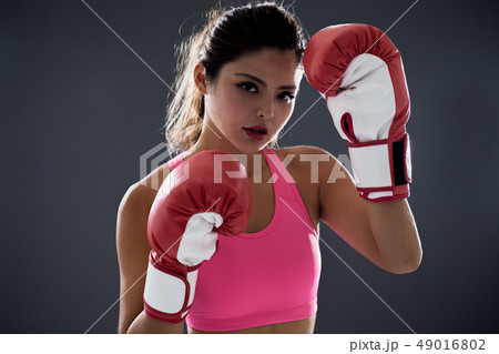woman posing in boxing gloves 49016802