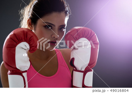 woman posing in boxing gloves woman posing in boxing gloves 49016804
