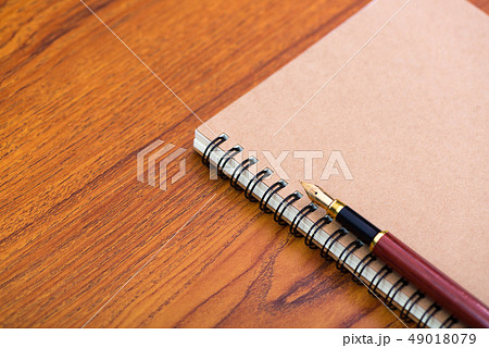 Fountain pen or ink pen with notebook paper on 49018079