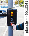 pushing a button of a signal traffic light at pedestrian crossing 49018361