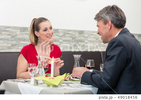 Couple enjoying dinner Couple enjoying dinner 49018456