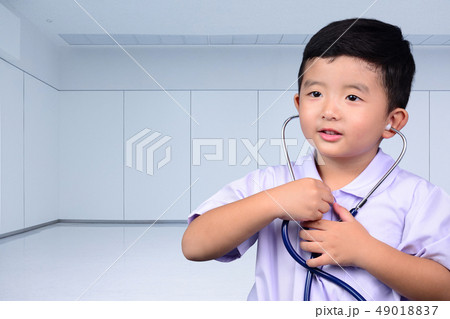 Asian Thai kid with medical stethoscope looking at 49018837