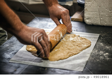 Male hands roll out shortbread gingerbread dough. 49018961