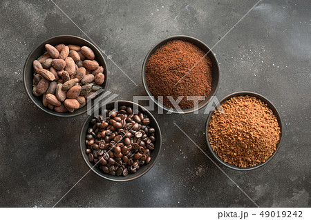 Concept of cocoa and coffee beans in bowls. 49019242