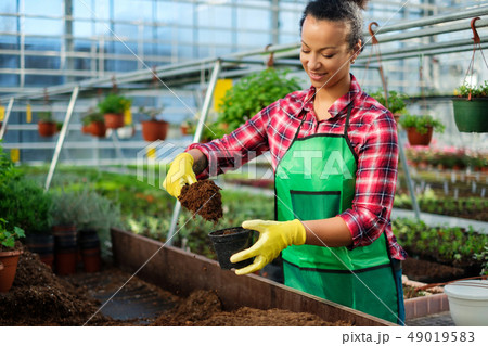 Black woman working in a botanical garden 49019583