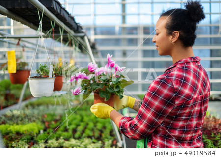 Black woman working in a botanical garden 49019584