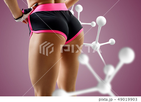Athletic woman standing near white molecule chain. 49019903