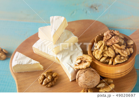 Cheese camembert or brie with walnut kernels 49020697