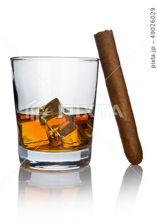 A glass of whiskey cooled with ice cubes and a A glass of whiskey cooled with ice cubes and a 49026029