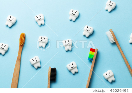 Healthy white teeth are smiling on blue background with toothbrush toothbrushes 49026492