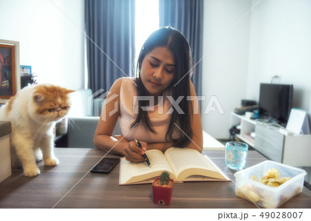 Beautiful Asian woman read book with cat Beautiful Asian woman read book with cat 49028007