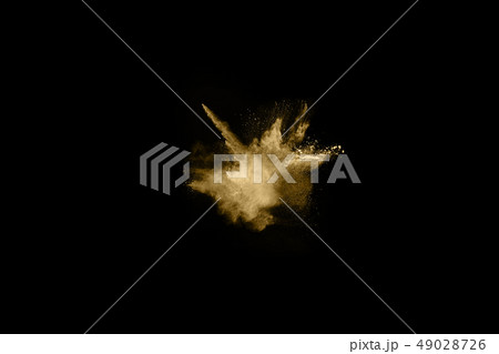 Golden powder explosion on black background. 49028726