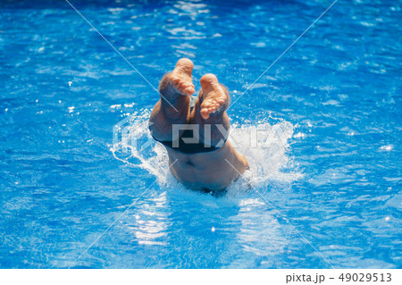 a man jumps into the pool. Swimmer in the water a man jumps into the pool. Swimmer in the water 49029513