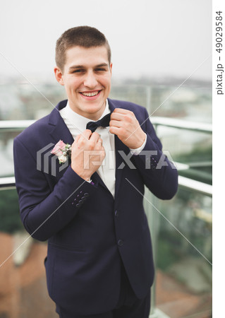 Headshot portrait of young man smiling isolated on outside outdoors background Headshot portrait of young man smiling isolated on outside outdoors background 49029584