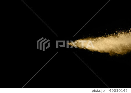 Golden powder explosion on black background. Golden powder explosion on black background. 49030145
