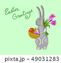 Easter bunny holding a basket with big paschal eggs 49031283