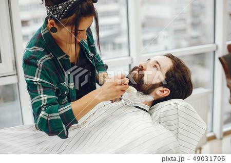 Stylish man sitting in a barbershop Stylish man sitting in a barbershop 49031706