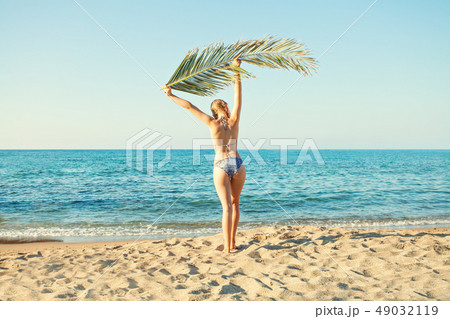 Young girl enjoying sun, relaxing on sea beach Young girl enjoying sun, relaxing on sea beach 49032119