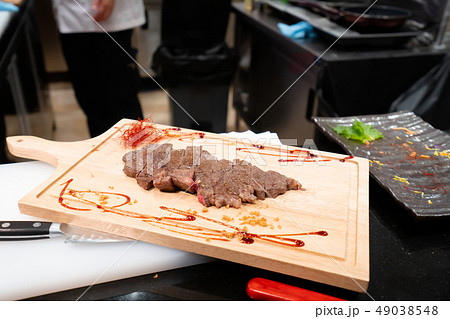 Beef sliced for dinner on wooden chopping board Beef sliced for dinner on wooden chopping board 49038548