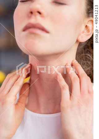 Disturb young woman closing her eyes and scratching neck Disturb young woman closing her eyes and scratching neck 49041213