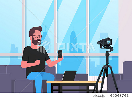 guy technology blogger recording video on camera man showing new smartphone functional testing blog 49043741