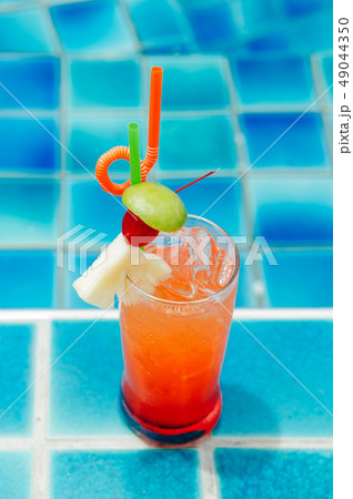 Orange italian soda at pool side by the beach 49044350