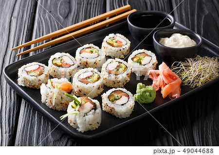 Asian uramaki rolls with salmon and crabs closeup Asian uramaki rolls with salmon and crabs closeup 49044688