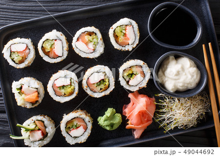 set of Japanese rolls uramaki served with sauces, 49044692