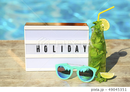 Light letterbox with word Holiday, hat, sunglasses Light letterbox with word Holiday, hat, sunglasses 49045351