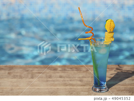Glass with a bright blue lagoon cocktail on the 49045352