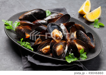 Delicious mussels with tomato sauce and parsley 49046860