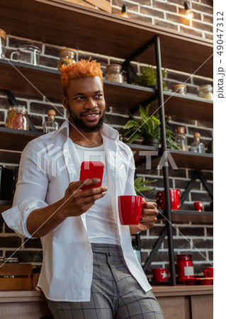 Pleasant good looking man using his smartphone Pleasant good looking man using his smartphone 49047312